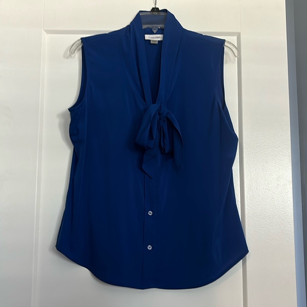 Bright blue sleeveless blouse